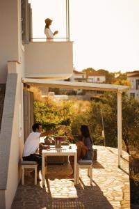 a man and a woman sitting at a table on a patio at Birds Bay Resort in Petra
