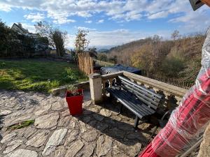 a bench sitting on a stone patio with a view at Lacouty le paradis! in Junhac
