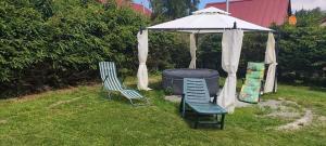 two chairs and a gazebo in a yard at Zlatý Žabák in Suchý