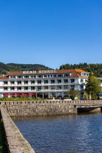 a large hotel on the side of a body of water at Hôtel Beau Rivage in Gérardmer