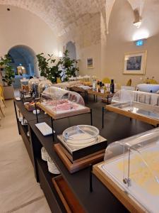 a store with tables with food on them at Chiostro dei Domenicani - Dimora Storica in Lecce