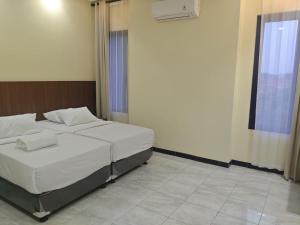 a bedroom with a bed in a room with a window at green hotel 2 ciamis in Ciamis +21 photos