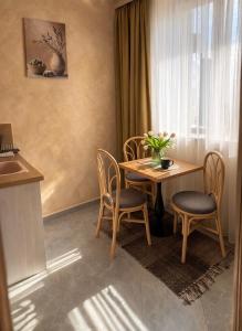 a dining room with a table and chairs and a window at Port Lake Hotel in Beloslav