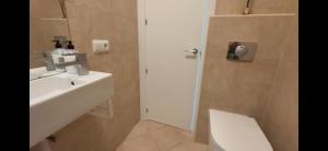 a bathroom with a sink and a toilet and a shower at Apartament w Esteponie in Estepona +34 photos