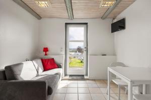 a living room with a couch and a table at Sorø Camping & Cottages in Sorø