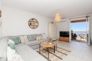 a living room with a couch and a table at Clara YourHostHelper in Montauroux