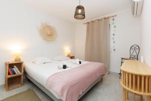 a bedroom with a bed with a pink blanket at Clara YourHostHelper in Montauroux +19 photos