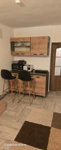 a kitchen with a table and two chairs in a room at Cazino4Love in Constanţa