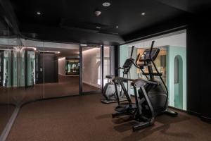 a gym with two tread machines in a room at CMYK Boutique Hotel in Bangkok