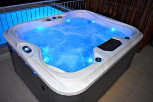 a jacuzzi tub with blue water in a room at Villa Anastasia Sandy Beach Villas - Heated Private Overflow Pool - Hot Tub - Games Room - Private Beach Area in Polis Chrysochous