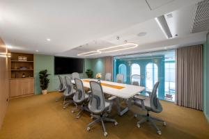 an office with a conference room with a table and chairs at CMYK Boutique Hotel in Bangkok