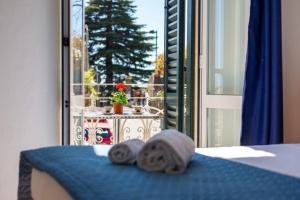 a bedroom with a bed with two towels on it at Locanda Milano 1873 in Brunate