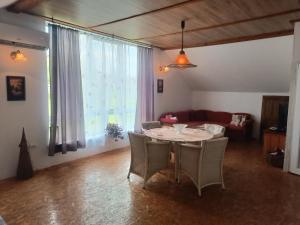 a living room with a table and chairs and a couch at Imanje Mihailovic 1 in Pružatovac