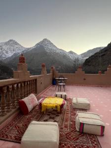 a balcony with beds and a view of mountains at Atlas Green Lodge in Imlil