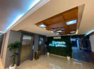 a lobby of an office building with a sign on the wall at Gurunandanam-Fully furnished Deluxe Apartment East Nada Guruvayur in Guruvāyūr