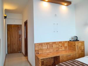 a bedroom with a wooden cabinet in a room at The Three Oaks Boutique Hotel in Mussoorie