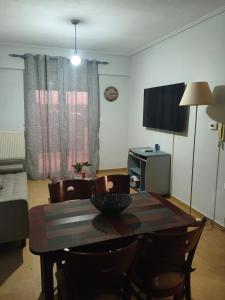 a dining room table and chairs in a room at Ippokratis 1 in Larisa