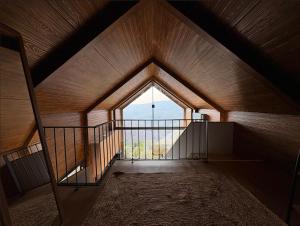 an attic room with a large window and a balcony at Casa de Sobreiros in Amarante
