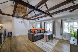 a living room with a couch and a table at Modern 1 Bed - Beams - Parking in Stamford