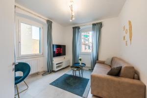 a living room with a couch and a tv at La Scaletta 10 min from train station for Cinque Terre! in La Spezia