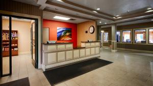 a lobby of a store with a clock on the wall at Best Western Plus Kalamazoo Suites in Kalamazoo