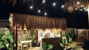 a building with a bunch of straw roof at Villa Isleñas - Solar, Starlink, Pool in General Luna +26 photos