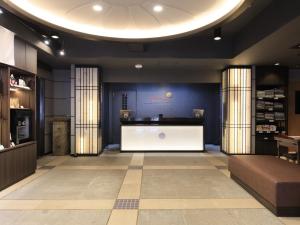 a store lobby with a large white reception desk at Kikunoya in Miyajima +162 photos