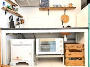 a kitchen with a counter top and a microwave at Can PONÇ PARRA in Santanyi +62 photos