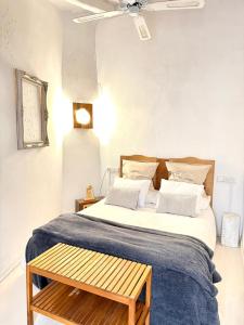 a bedroom with a large bed with a blue blanket at Can PONÇ PARRA in Santanyi