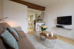 a living room with a couch and a table at HolidaysInParis - Bourg Tibourg in Paris