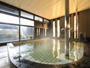 a swimming pool with a shower in a building at Kikunoya in Miyajima