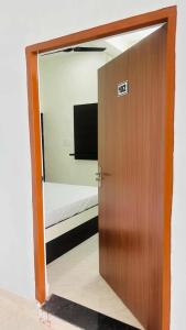 a door leading to a bedroom with a bed in a room at Hotal Shivaay inn in Barāgaon