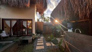 a house with a pathway next to a building at Villa Isleñas - Solar, Starlink, Pool in General Luna