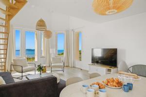 a living room with a couch and a table with food on it at Duplex d'exception face à la mer in Hyères