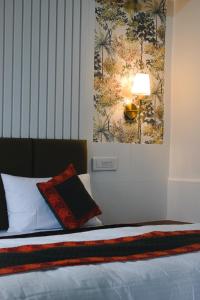 a bedroom with a bed with a picture on the wall at The Himalayan Roots in Kulu