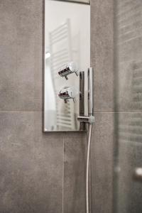 a shower in a bathroom with a mirror at La Scaletta 10 min from train station for Cinque Terre! in La Spezia