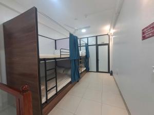a room with bunk beds and a hallway at HT Airport Inn in Phù Xá Ðoài