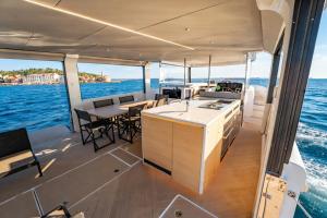 a kitchen and dining area on a boat at Aquaïa, Saint-Tropez by sea in Cogolin
