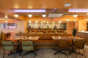 a restaurant with tables and chairs and a bar at CMYK Boutique Hotel in Bangkok