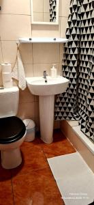 a bathroom with a toilet and a sink at K14 Rooms Lublin in Lublin +58 photos