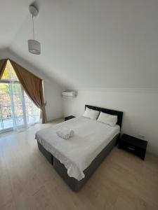 a bedroom with a large bed with white sheets at Amazonica MAGİC DREAM in Kemer +23 photos