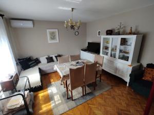a living room with a table and a couch at Šumarev konak in Valjevo +17 photos
