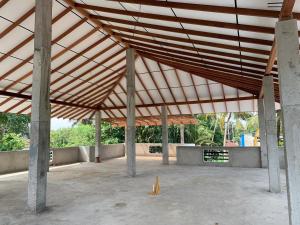 a large building with a large wooden roof at Abey Villa Madiha Beach Surf Stay in Matara +38 photos