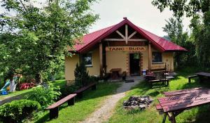 a building with benches in front of it at DG EWA w Polańczyku in Polańczyk