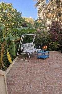 a white chair sitting on a brick patio at Beach Family Villa - Private Pool - Sea view - Up to 14 guests- only 40 Meters to the Beach! in Alexandria +17 photos