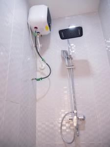 a shower in a bathroom with a blow dryer at Captain Residency Hotel in Lagos