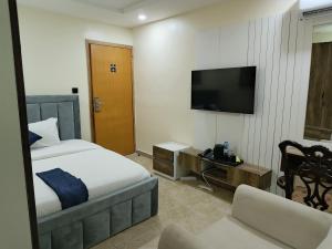a hotel room with a bed and a television at Captain Residency Hotel in Lagos