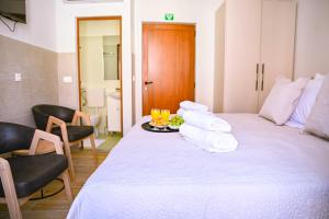 a room with a bed with two glasses and towels at Stradun Main Street Residence in Dubrovnik