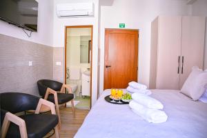 a room with a bed with chairs and a tray of towels at Stradun Main Street Residence in Dubrovnik +34 photos