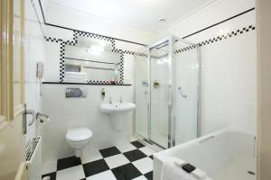 a bathroom with a toilet and a sink and a shower at Arbutus Hotel in Killarney